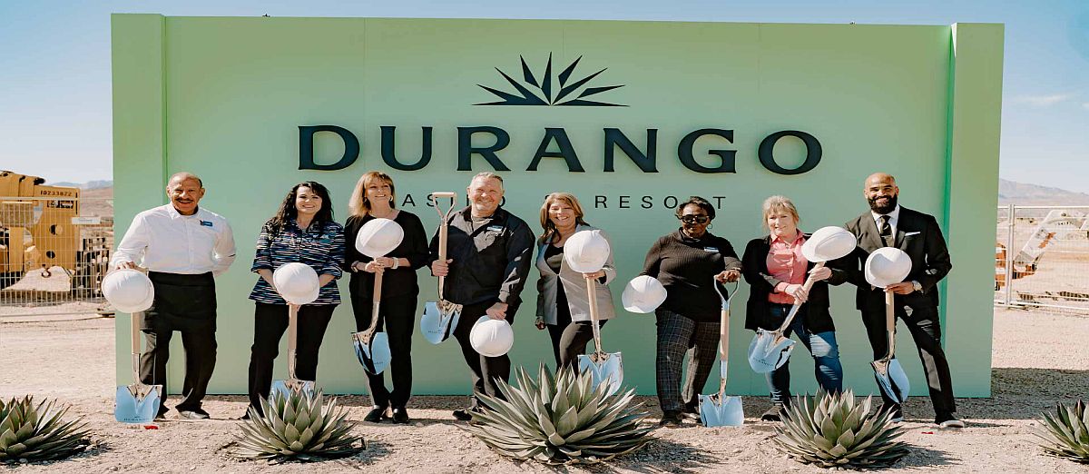 The executive team of Durango Casino in front of the casino's sign