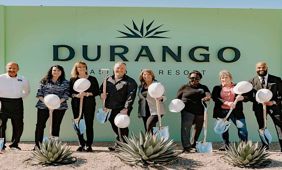 The executive team of Durango Casino in front of the casino's sign