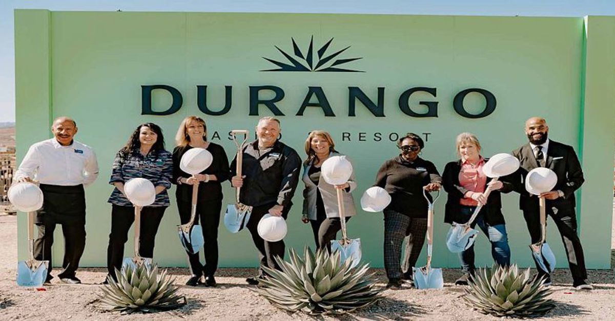 The executive team of Durango Casino in front of the casino's sign